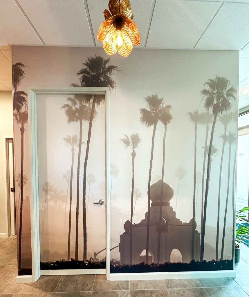 Amaya Wellness Spa interior featuring palm tree mural and lotus light fixture